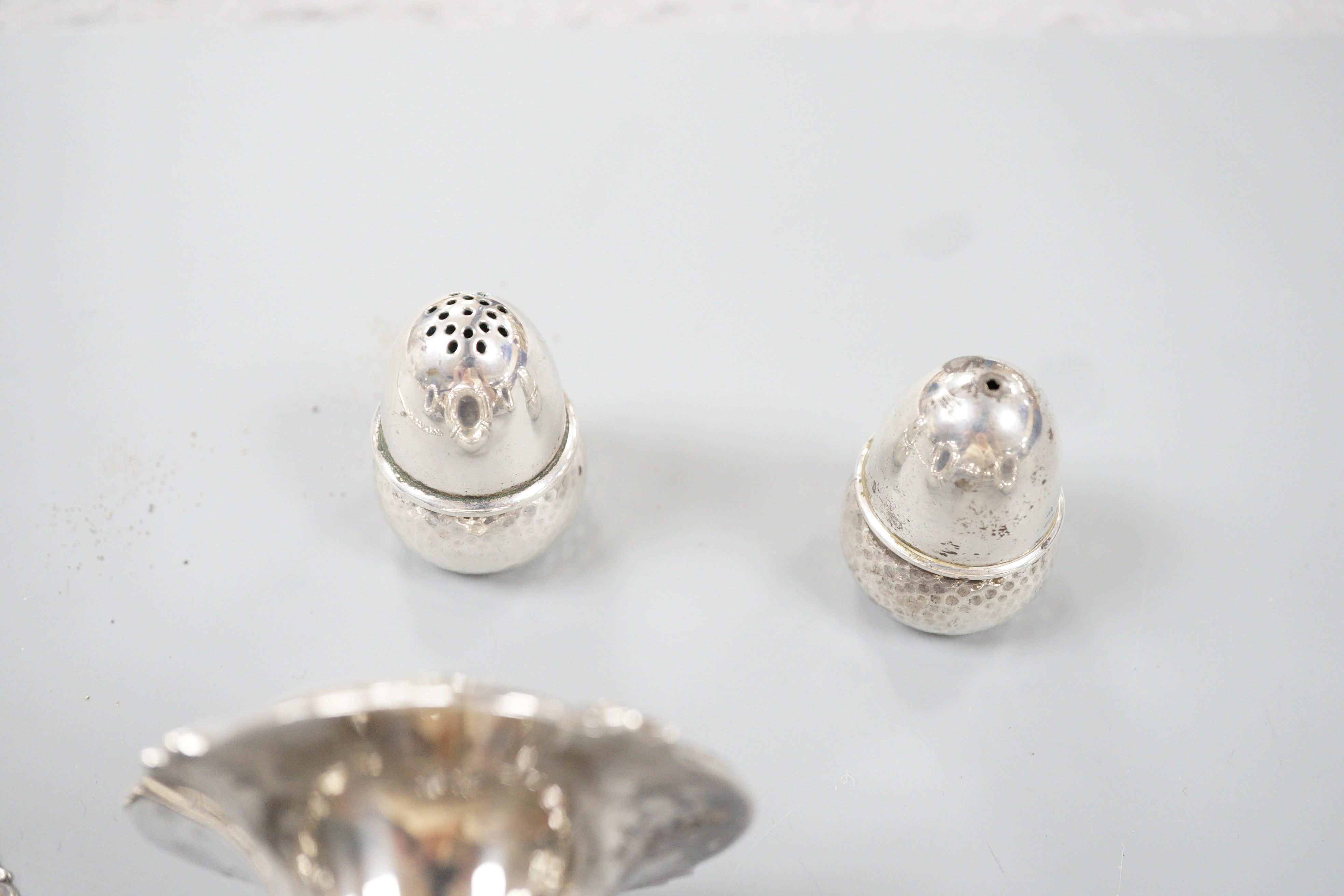 A 20th century Danish 830 standard white metal candelabrum, height 25.6cm, weighted, a pair of Danish white metal acorn condiments and a Danish white metal paper knife.